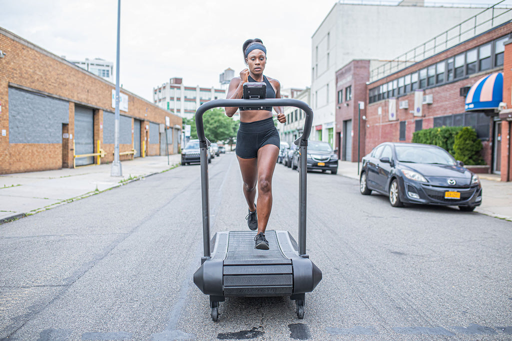 View from the front of a person running on the Assaultrunner treadmill positioned in the middle of the street.